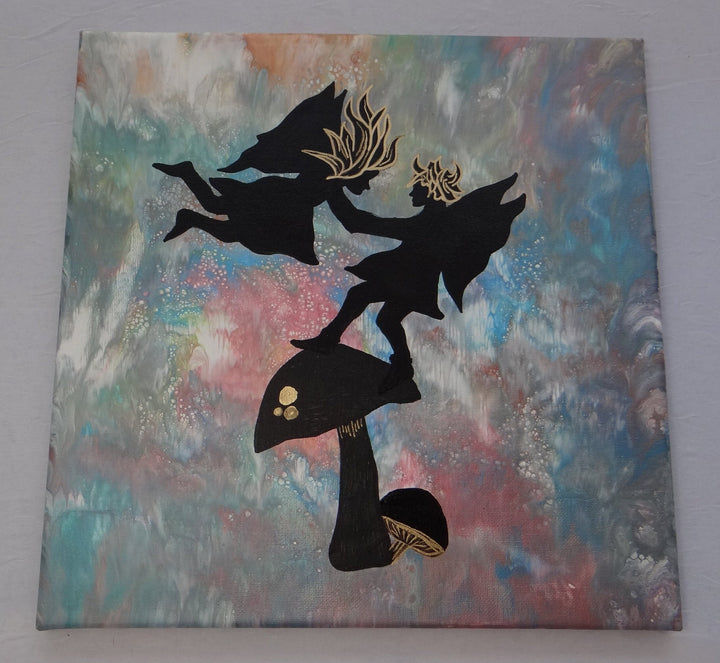 A 12"x12" acrylic pour painting featuring silhouetted fairies dancing atop a mushroom with metallic gold detailing on a dreamy, swirling background by Blue St Designs.