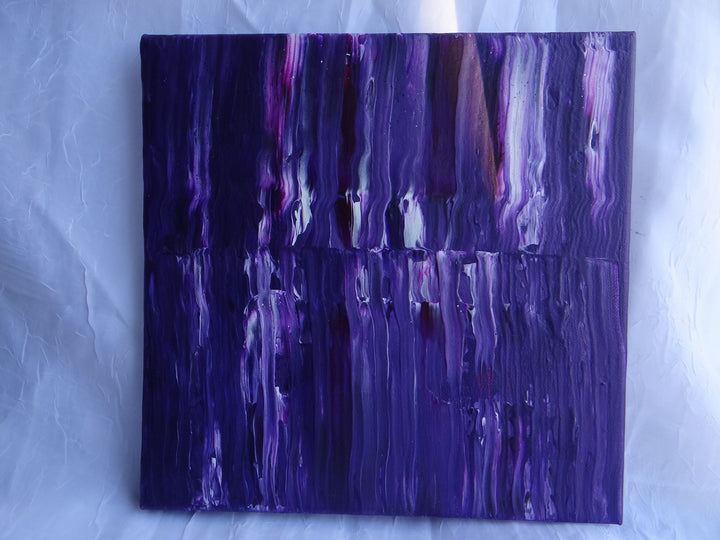 A 10"x10" acrylic pour painting titled Purple Stripe, featuring cascading streaks of deep violet, magenta, and white on canvas. The textured swipe technique enhances the fluid motion, creating a visually dynamic and layered effect.