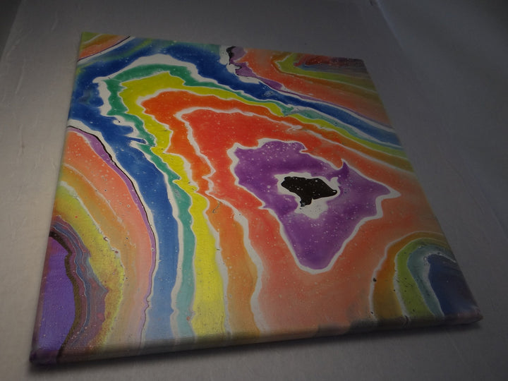 Angled shot of Rainbow Geode, emphasizing its color-shifting, iridescent hues and layered, geode-like design.