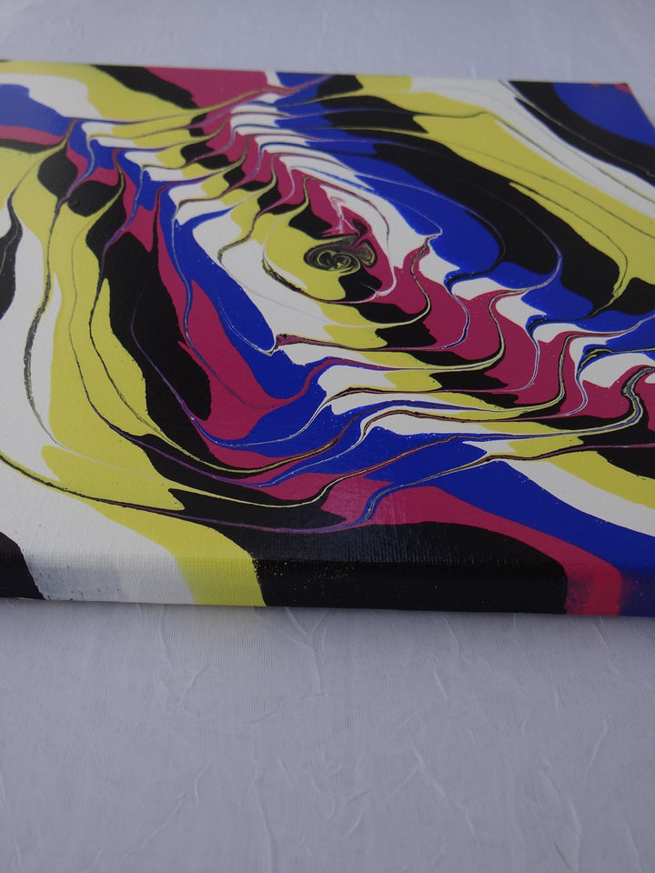 Angled perspective of Shock Wave, an abstract acrylic pour on canvas with bold contemporary colors.