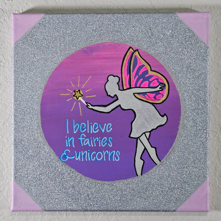 Fairies & Unicorns – 10x10 Acrylic Fantasy Canvas Painting featuring a fairy with butterfly wings against a glittery silver background.